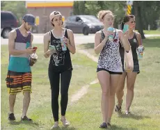  ??  ?? From left: Justin Beckstrand, Kaitlin Beckstrand and Brokoe Vanneste play Pokemon Go in Leif Erickson Park on July 17, as mom Wendy Beckstrand tags along for the walk.