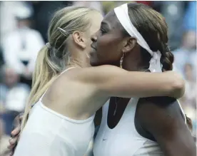  ?? ASSOCIATED PRESS FILE PHOTO ?? Maria Sharapova, left, embraces Serena Williams after defeating her to win the women’s singles final at Wimbledon in 2004. The fourth-round French Open match between Williams and Sharapova on Monday will be their 22nd head-to-head meeting.