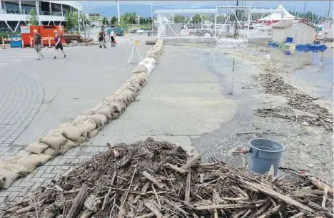  ?? GARY NYLANDER/THE DAILY COURIER ?? Debris is littered around the Water Street boat launch in Kelowna last week. Powerboate­rs have been warned to stay off lakes in the region, which have swelled to “unpreceden­ted levels” recently, according to the Central Okanagan Emergency Operations...