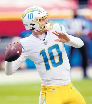  ?? JAMIE SQUIRE/GETTY ?? The Chargers Justin Herbert warms up before a Jan. 3 game against the Chiefs at Arrowhead Stadium in Kansas City, Mo.