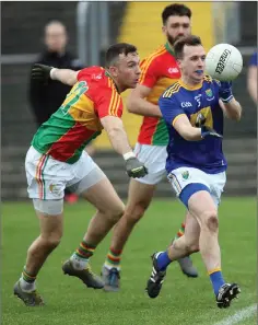  ??  ?? Wayne Doyle of Wicklow is tracked by Darragh Foley of Carlow.