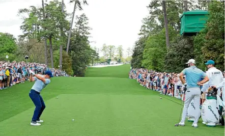  ?? — AFP ?? Hard at work: Rory McIlroy plays a shot during a practice round prior to the US Masters at Augusta National Golf Club on Monday. McIlroy is in great form going by his seven top 10 finishes in seven starts this year.