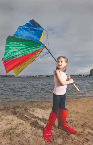  ?? Picture: GLENN HAMPSON ?? Addison Boyd, 6, from Brisbane gets ready for expected showers.