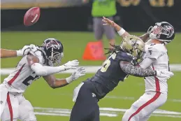  ??  ?? Ryan is hit by Saints outside linebacker Demario Davis on Nov. 22. After George Floyd’s killing, Ryan said: ‘For our team, it was the third or fourth time talking about the same things. If we continue to take the same approach, and guys continue to do what we’ve been doing, that’s not going to work.’