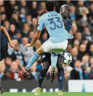  ?? — AFP ?? No gentleman’s game: Manchester City’s Gabriel Jesus bumping into Napoli’s Kalidou Koulibaly in the Champions League match at the Etihad on Tuesday.