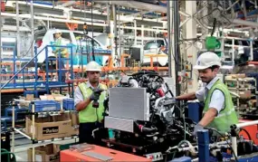  ??  ?? Employees work inside the General Motors plant in Talegaon, about 118 km (73 miles) from Mumbai September 4, 2012. General Motors Co began initial production of its first ever Chinese-designed car for the Indian market this week, a major step for the...