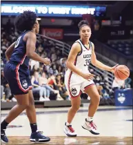  ?? Jessica Hill / Associated Press ?? UConn’s Azzi Fudd dribbles as Christyn Williams, left, defends during First Night events Oct. 15.