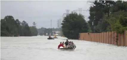  ?? Karen Warren / Houston Chronicle ?? Private boats bring residents out of a neighborho­od at Townsen Road and FM 1960 as heavy rains from Hurricane Harvey continued filling the San Jacinto River on Aug. 29.