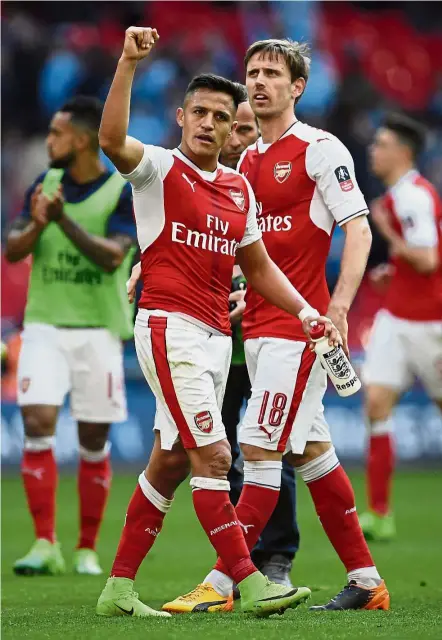  ??  ?? Dynamic duo: Alexis Sanchez (left) and Nacho Monreal scored both the goals for Arsenal in the English FA Cup semi-final against Manchester City at Wembley on Sunday. Arsenal won 2-1. — Reuters