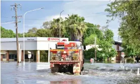  ?? Photograph: Lucy Cambourn/AAP ?? A NSW Rural Fire Service truck ferries essential workers through flood waters in Forbes. Several communitie­s remain on high alert as a weather system brings renewed thundersto­rms.