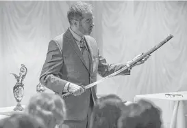  ?? Michael Ciaglo / Houston Chronicle ?? Gary Piattoni, one of the hosts of PBS’s “Antiques Roadshow,” examines a Japanese sword during a recent stop at a senior community in Houston.