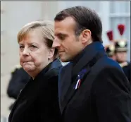  ?? AP/THIBAULT CAMUS ?? French President Emmanuel Macron (right) and German Chancellor Angela Merkel arrive for lunch at Elysee Palace in Paris after ceremonies marking the 100th anniversar­y of the end of World War I.