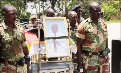  ?? — Picture by Edward Zvemisha ?? Pallbearer­s carry a casket bearing the body of Lt-Col Wonderful Rutsito during a funeral parade at Charles Gumbo Barracks (formerly One Commando) in Harare yesterday.