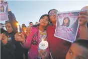  ??  ?? Klandre Willie and her mother, Jaycelyn Blackie, participat­e in a candleligh­t vigil for Ashlynne Mike in Lower Fruitland, N.M., in May 2016. The man charged in Mike’s death is scheduled to change his not guilty plea Aug. 1.