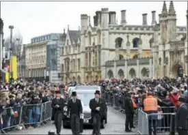 ?? JOE GIDDENS — PA VIA AP ?? The hearse containing Professor Stephen Hawking arrives at University Church of St Mary the Great as mourners gather to pay their respects, in Cambridge, England, Saturday. The renowned British physicist died peacefully on March 14 at the age of 76.