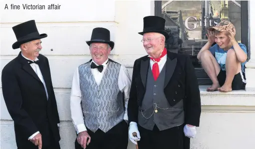  ?? PHOTO: STEPHEN JAQUIERY ?? Three suitably attired gents enjoy their day out at the Oamaru Victorian Heritage Celebratio­ns on Saturday, while Will Banford (8), of Oamaru, sneaks up on them. They are (from left) Gilbert Black, of Milton, Bernard Flannery, of Milburn, and Geoff Swift, of Dunedin.