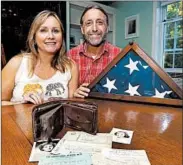  ?? ELISE AMENDOLA/AP ?? Sharon McCusker Moore and her brother, Steven, display their father's wallet and contents last week in Dover, N.H.