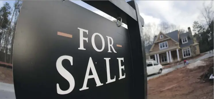  ?? THE ASSOCIATED PRESS/FILE ?? Despite strict new mortgage lending rules coming into place, a leading economist predicts a “modest” improvemen­t in Edmonton’s housing market in 2018.