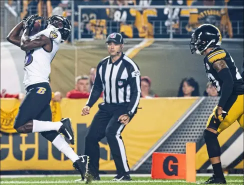  ?? Steph Chambers/Post-Gazette ?? Wide receiver John Brown catches a touchdown in the first quarter to put the Ravens ahead, 7-0, Sunday night at Heinz Field.