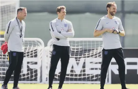  ??  ?? England assistant Steve Holland, striker coach Allan Russell and manager Gareth Southgate at training.