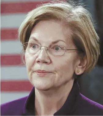  ?? STAFF PHOTO BY ANGELA ROWLINGS ?? GETTING THE TOUGH QUESTIONS: U.S. Sen. Elizabeth Warren reacts to a reporter’s question during a news conference at Hanscom Air Force Base yesterday.