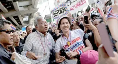  ??  ?? Protest leader Suthep Thaugsuban (centre) has rejected any compromise with the government.