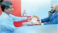  ??  ?? Naleen Edirisingh­e Deputy General Manager – Branch Credit of Pan Asia Bank is seen accepting the first deposit at the Negambo branch opening.