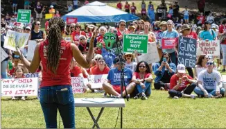  ?? PHOTOS BY STEVE SCHAEFER/STEVE.SCHAEFER@AJC.COM ?? Angela Frerrell Zabala speaks Saturday in Piedmont Park as part of a rally organized by Georgia Moms Demand Action with the nonprofit Everytown for Gun Safety.