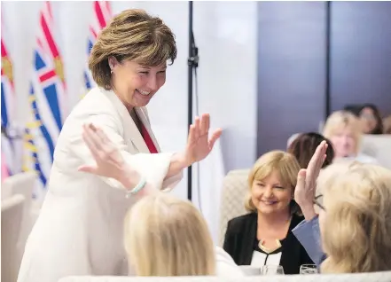  ?? — THE CANADIAN PRESS ?? Premier Christy Clark receives high-fives before addressing a Liberal party lunch event in Vancouver on Wednesday. The Liberals will deliver their speech from the throne on Thursday.