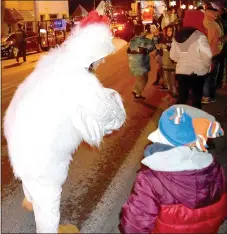  ?? Westside Eagle Observer/MIKE ECKELS ?? The Simmons chicken hands out candy to children along Main Street during the Decatur Christmas Parade through downtown Decatur Dec. 7. (See more photos on Page A5.)