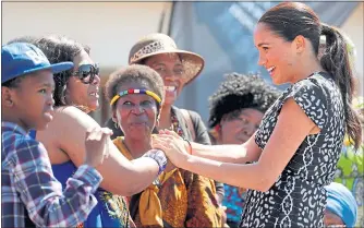  ??  ?? Meghan seemed relaxed on the couple’s recent trip to South Africa