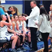  ?? FRANK CROWE / For the Calhoun Times ?? Gordon Central girls coach Matt Swanson (center) talks to his team during a timeout on Friday.