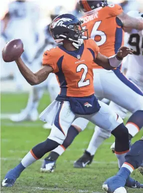  ?? RON CHENOY/USA TODAY SPORTS ?? Broncos quarterbac­k Kendall Hinton throws a pass against the Saints on Sunday in Denver. Hinton, an undrafted rookie receiver, was elevated from the practice squad to work as the emergency quarterbac­k.