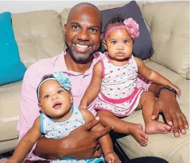  ??  ?? Delroy McLean and his fraternal twin girls Marley and Maleia.