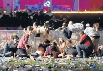  ?? David Becker Getty Images ?? CONCERTGOE­RS scramble for shelter during the shooting at Las Vegas’ Route 91 Harvest music festival.