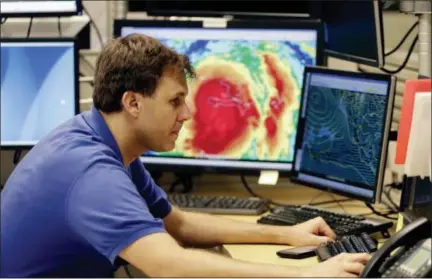  ?? LYNNE SLADKY — THE ASSOCIATED PRESS ?? Hurricane specialist Eric Blake monitors the path of Hurricane Matthew at the National Hurricane Center in Miami on Tuesday.