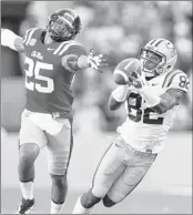  ??  ?? LSU receiver James Wright pulls in a 48-yard first-half catch in front of Ole Miss defensive back Cody Prewitt.