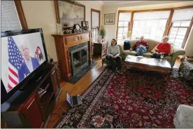  ?? CHARLES REX ARBOGAST / ASSOCIATED PRESS ?? Lally Doerrer (left) and neighbors Douglas and Marlene Groll watch Joe Biden during his Illinois virtual town hall in Doerrer’s living room in March in Chicago. The coronaviru­s has hemmed in Biden’s campaign.