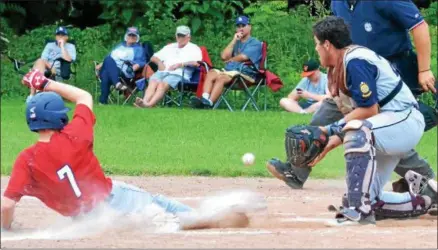  ?? KYLE MENNIG — ONEIDA DAILY DISPATCH ?? Sherrill Post’s Zach Nell (7) slides safely into home as Helmuth-Ingalls Post catcher Thomas Labayweski (25) fields the throw during their game in Clinton on Friday.