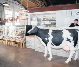  ?? CAPEHART PHOTOGRAPH­Y/COURTESY ?? Betsy the cow stands guard near the entrance of The Butcher Shop Beer Garden & Grill, which recently opened in West Palm Beach.