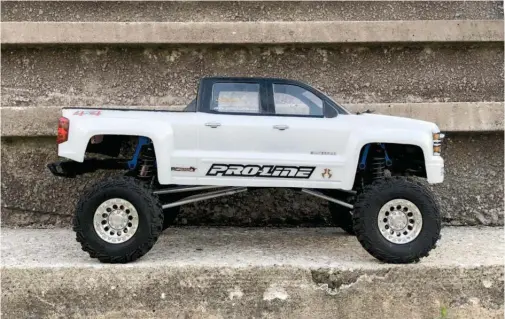  ??  ?? - Silver 1.9 bead locks with RC4WD Goodyear Wrangler MT/R 1.9s - Custom links with Integy M4 rod ends
- Pro-line Racing 2014 Silverado Body
- Integy blue shock towers with KYX shocks
- SSD SCX10 II Pro44 Titanium Steering Link Set
- Power HD 20kg steering servo with an alloy servo
relocation front bumper mount
- Holmes Hobby 35T Trailmaste­r 540 motor
and Hobbywing 1060 esc
- Zee Power 4600amh 2S Lipo shorty pack on
a low CG battery relocation plate
- Headlights, fog lights, taillights and rock lights