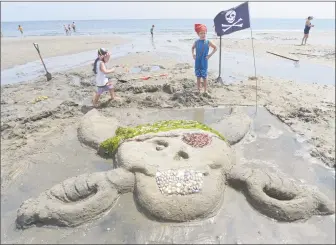  ?? Erik Trautmann / Hearst Connecticu­t Media ?? Matthew and Andrew Epstein, 7 and 4, participat­e in the annual PAL Sand Sculpting Contest on Saturday at Penfield Beach in Fairfield. Prizes were awarded for Best Castle, Most Original, Most Artistic, and Most Realistic sculpture.