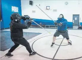  ??  ?? Brennan Faucher, right, and John MacPhail battle during a class at the Niagara School of Arms.