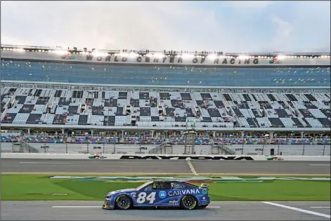  ?? Associated Press ?? On the track: Jimmie Johnson (84) drives down pit road during a practice session for the NASCAR Daytona 500 auto race at Daytona InternaUJP­OBM 4QFFEXBZ 'SJEBZ JO %BZUPOB #FBDI 'MB +PIOTPO UPQQFE UIF mSTU QSBDUJDF TFTTJPO )F SFBDIFE B TQFFE PG NQI