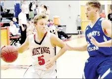  ?? PHOTO BY RICK PECK ?? McDonald County’s Boston Dowd gets around St. Mary’s Billy Dickey during Colgan’s 65-43 win Dec. 13 at McDonald County High School.