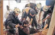  ??  ?? ■ Members of the Syrian civil defence volunteers, also known as the White Helmets, remove a victim from the rubble of his house. AFP FILE