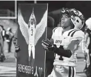  ?? Kin Man Hui / Staff photograph­er ?? Fort Bend Marshall's Jaquze White holds a poster in remembranc­e of senior safety Drew Conley after the Buffalos won Friday night in San Antonio.