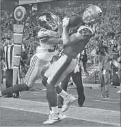  ?? Winslow Townson Associated Press ?? CODY HOLLISTER of the Patriots beats Donte Deayon of the Giants for a touchdown catch on the final day of NFL exhibition­s. The Giants won, 40-38.