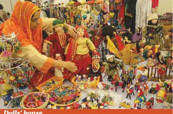  ?? Online ?? A woman displays dolls at her stall to attract visitors during the Daachi Arts and Crafts ■ Exhibition organised by the Daachi Foundation in Model Town, Lahore, yesterday.