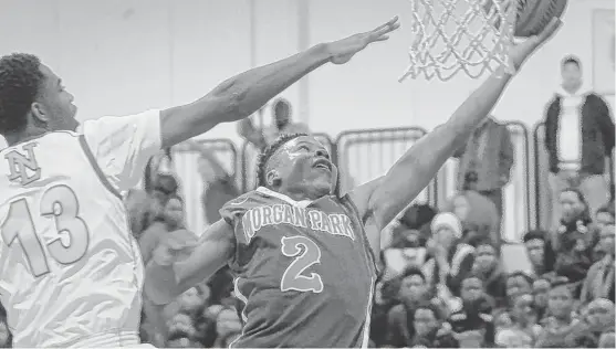  ?? | WORSOM ROBINSON/FOR THE SUN-TIMES ?? Morgan Park senior guard Charlie Moore (32 points) scored 12 points in the third quarter to help the Mustangs take a 64-55 lead.